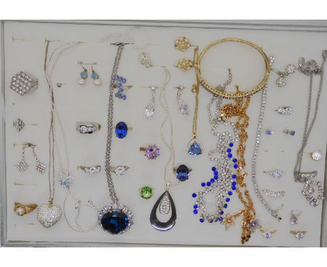 A gold plated silver bangle set with tanzanite, two signed Swarovski crystal solitaire rings and other items Condition Report