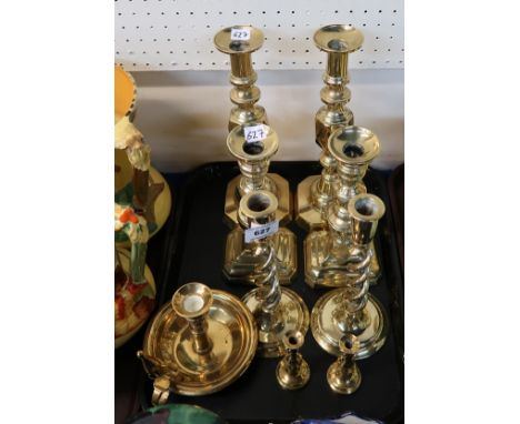 A pair of King of Diamonds brass candlesticks, two other pairs of candlesticks, a pair of tapersticks and a chamber stick Con