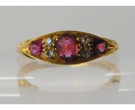 An 18ct gold red gem and diamond ring, hallmarked Birmingham 1908, size O, weight 2.6gms Condition Report: Available upon req