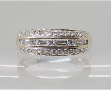 An 18ct white gold diamond dress ring, set with estimated approx 0.50cts of brilliant and baguette cut diamonds, finger size 