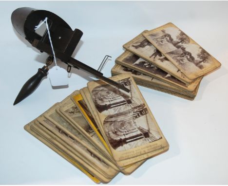 A vintage stereoscope viewer and collection of cards Condition Report: Available upon request