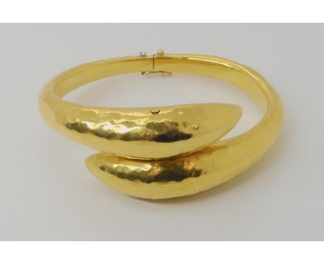 A bright yellow metal bangle stamped K22, weight 37.6gms Condition Report: Available upon request