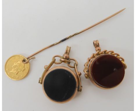 Two 9ct gold double sided agate fob seals, and a stick pin with an attached 1853 1 dollar USA coin, combined weight 12gms Con