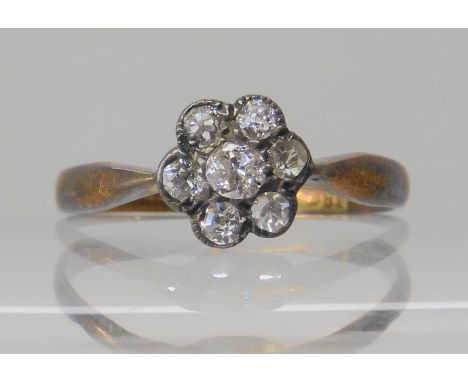 An 18ct gold diamond flower ring, set with estimated approx 0.22ct of old cut diamonds, size O1/2, weight 1.5gms Condition Re