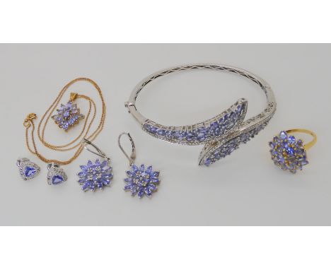 A collection of silver and tanzanite jewellery to include a bangle, ring, two pairs of earrings  and a pendant Condition Repo