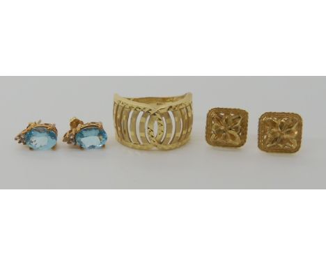 A 9ct gold wide patterned dress ring size N, a pair of 9ct gold apertite and white topaz earrings and another pair of 9ct ear