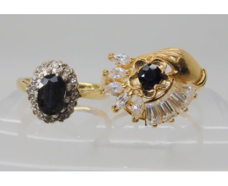 An 18ct gold sapphire and diamond cluster ring, size J, together with an 18ct blue and clear gem set ring size M, weight toge