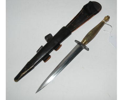 A steel commando dagger in leather scabbard, 34cm overall length Condition Report: Scabbard looks a bit modern, may be a repl