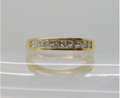 An 18ct gold diamond half eternity ring set with estimated approx 0.50cts of princess cut diamonds combined finger size N, we