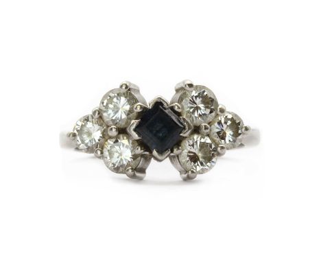 A platinum sapphire and diamond ring,a central square step cut sapphire, approximately 4mm, 'V' claw set, to a trefoil of bri