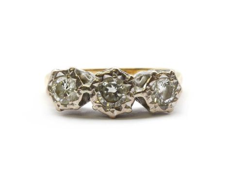 An 18ct gold three stone diamond ring, three brilliant cut diamonds in high white gold illusion settings, to chenier shoulder