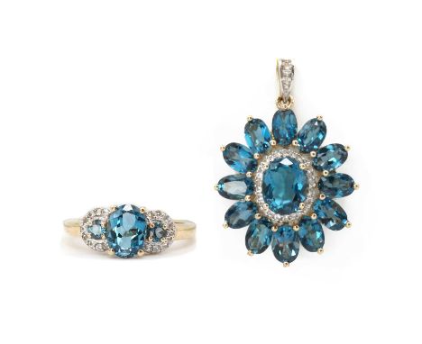 A 9ct gold blue topaz cluster pendant,with an oval mixed cut blue topaz, claw set, approximately 9 x 7mm, to surround of colo