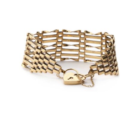 A 9ct gold gate bracelet, with twisted and plain links, to heart shaped padlock clasp and safety chain, London, 13.69gConditi