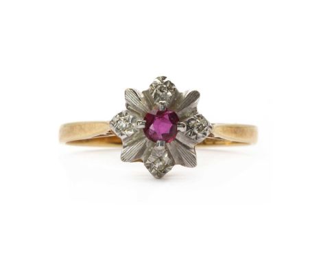 An 18ct gold ruby and diamond ring,a round mixed cut ruby, possibly synthetic, claw set, to a surround of illusion set eight 