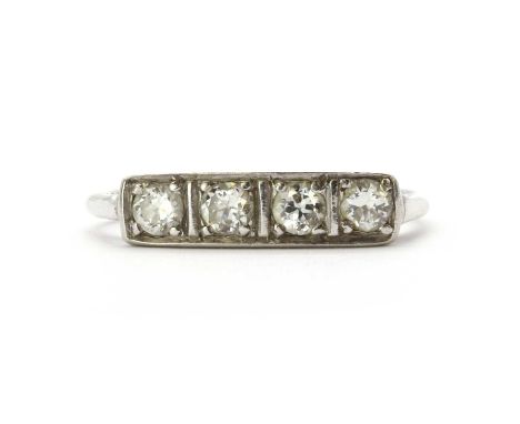 An Art Deco gold four stone diamond ring, with round brilliant cut diamonds, grain set, to a plain shank, with sizing beads f