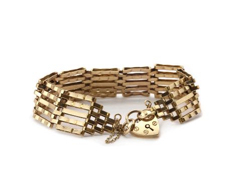 A 9ct gold gate bracelet,a five bar bracelet, with plain inner bars and crimped outer bars, to a heart shaped padlock and saf