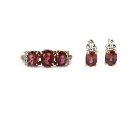 A 9ct gold rhodolite garnet and diamond ring,three oval mixed cut rhodolite garnets, claw set, to shoulders with a row of bri