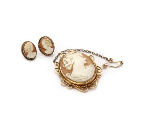 A gold shell cameo brooch,a carved shell cameo portrait of a lady, bezel set, to a surround with twisted wire and wire scroll