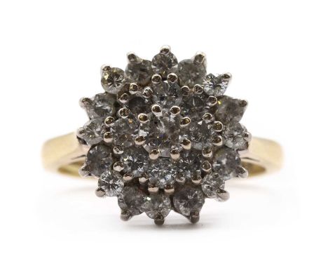 An 18ct gold diamond cluster ring,a central brilliant cut diamond, to two row surround of smaller brilliant cut diamonds, all