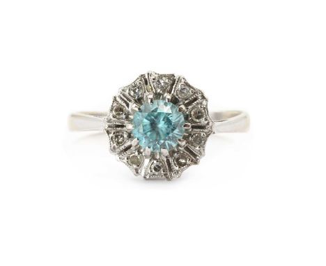 A white gold blue zircon and diamond ring,a round mixed cut blue zircon, claw set, to a surround of eight cut diamonds, mille