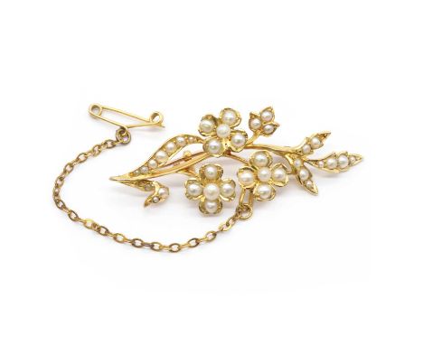 An Edwardian gold pearl spray brooch,split pearls and seed pearls, grain and peg set to a floral spray, with pin and 'C' catc