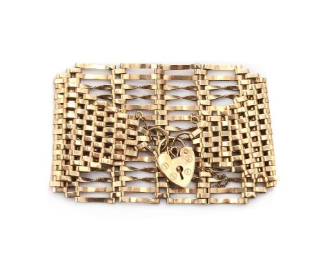 A 9ct gold fourteen row gate bracelet,fourteen rows of plain and twisted bars, to plain stepped links either side, to heart s