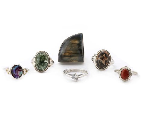 Six silver rings,comprising a silver labradorite ring, a silver moss agate ring, a silver cubic zirconia ring, a silver red j