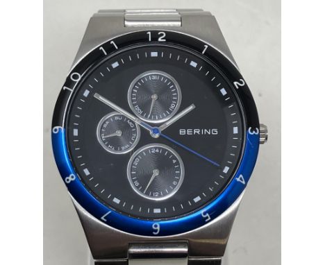 A gentleman's stainless steel Bering wristwatch 32339-702, in a glass case, with guarantee, instruction manual and spare link