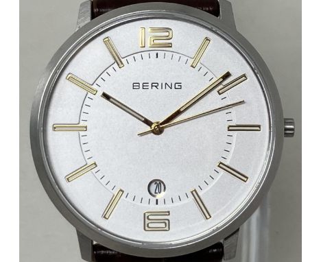 A gentleman's stainless steel Bering wristwatch 11139-501, on a leather strap, in a glass case, with guarantee and instructio
