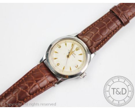 A gentleman's Rolex Oyster Perpetual wristwatch circa 1954, the white dial with gold coloured 'dagger' batons & hands, inner 