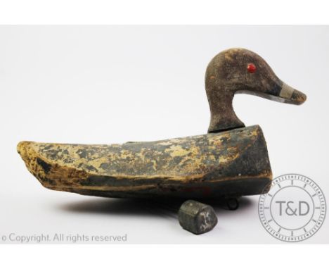 A Vintage early 20th century wooden decoy duck, with painted patina and lead weight, 35cm wide