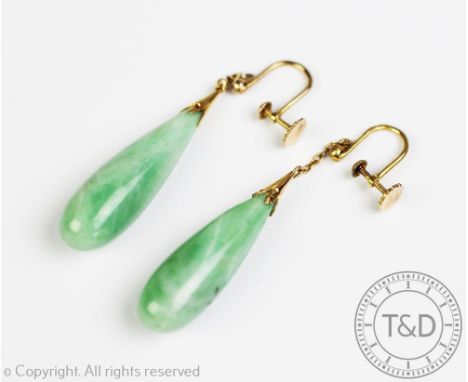A pair of jade set drop earrings, each designed as a polished drop, suspended from a fine chain with yellow metal screw fitti
