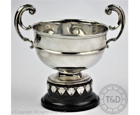 A two handled silver trophy, William Hutton & Sons, Sheffield 1933, with flying scroll handles and titled 'Cholmondeley Tenni