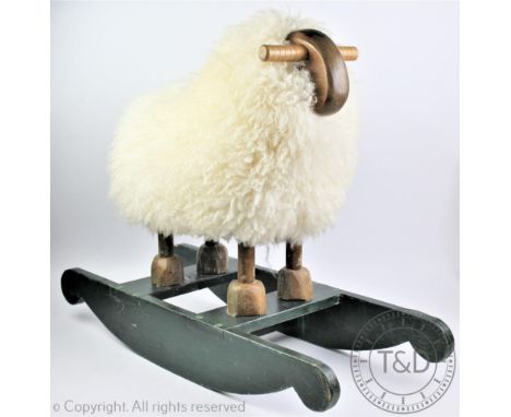 A vintage folk art sheepskin covered rocking sheep, 62cm high