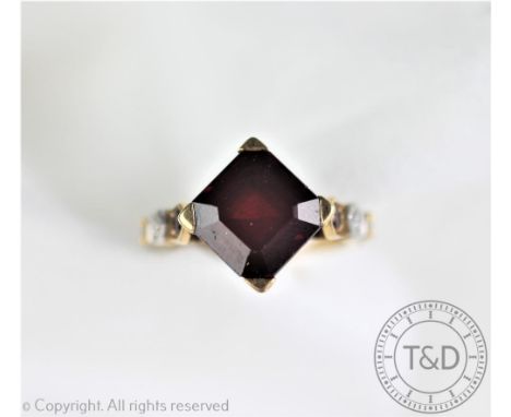 A garnet and diamond set dress ring, designed as a central square cut garnet within four claw setting, with garnets set to th