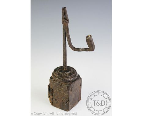 A primitive 18th century iron rush nip light, upon a later oak block base, 30cm high overall  CONDITION REPORT: The iron work
