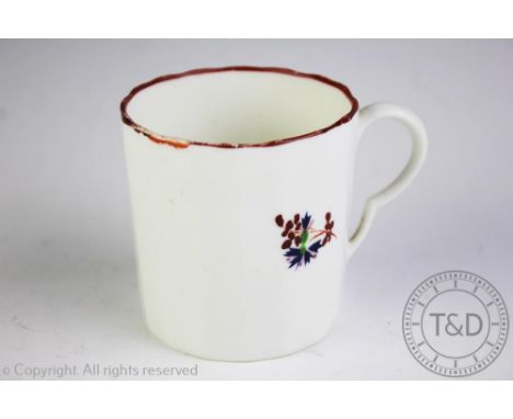 A Pinxton coffee can, circa 1800, with faceted body and decorated with polychrome sprigs below a russet line border, 7cm high