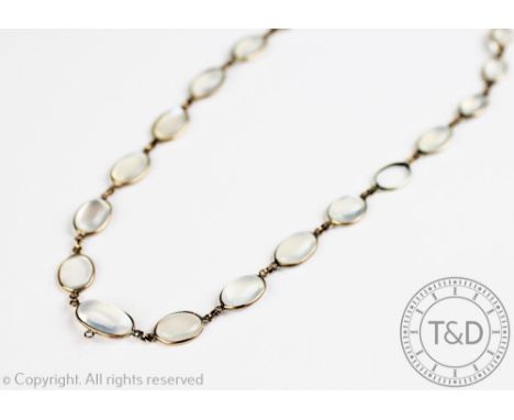A moonstone set necklace, designed as twenty graduated moonstones, all collet set in yellow metal and with attached barrel sn