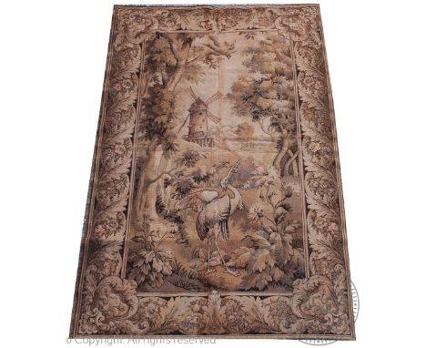 A Flemish style machine woven wall hanging tapestry, decorated engrisaille with a heron eating a fish amongst pond rushes ben