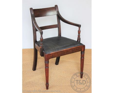 A late George III mahogany carver dining chair, with reeded arms on ring turned and tapered legs, 84cm H