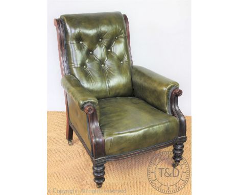 A late Victorian carved walnut library chair, with button back green leather upholstery, on turned legs, 94cm H