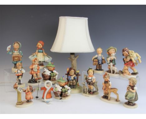 A collection of thirteen Goebel Hummel figures, including Little Drummer Trommler, Boots and Mothers Helper, with a Hummel la