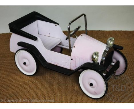 A French metal and plastic pink pedal car, 93cm long (Sold as a decorative item only)