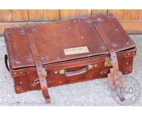A vintage tan leather suitcase, with brass clasps, 22cm H x 76cm W x 41cm D