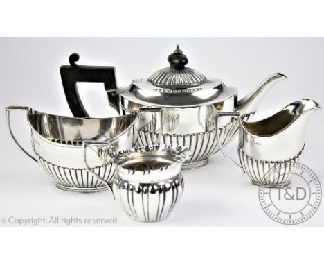 A silver bachelor's three piece tea service, Goldsmiths and Silversmiths Co Ltd, Sheffield 1884, each of oval stop-fluted for