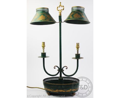 A students desk lamp in the 19th century toleware style, decorated with gilt highlights against a green reserve, adjustable t