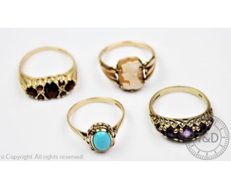 An amethyst set 9ct gold ring, a garnet set 9ct gold ring, a turquoise set 9ct gold ring and a carved shell cameo set ring, g