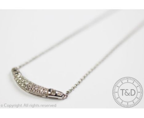 A diamond set necklace, designed as a central curved panel, pave set with brilliant and baguette cut diamonds, with an attach
