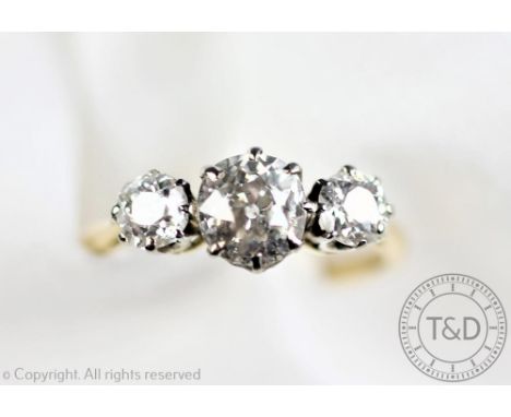 A three stone diamond ring, designed as three graduated old cut diamonds, (measuring approx 0.30ct 1.20ct and 0.30ct) each wi