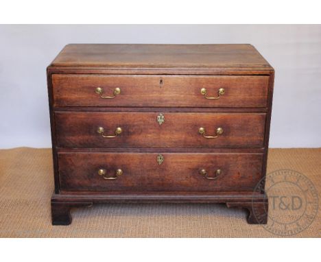 A George III oak chest, of three long drawers, on bracket feet, formerly the base of a chest on chest, 84cm H x 107cm W x 54c